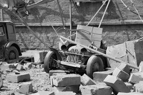 ruined building and wrecked cars, old photo