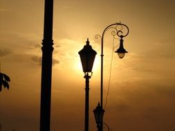 silhouette of a street lamp against a beautiful sunset