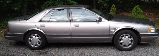 cadillac stands on the edge of the road
