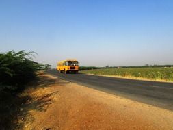 orange bus on road, india, navalgund