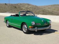 Green retro car on the road