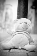 black and white picture of the lost toy on a street