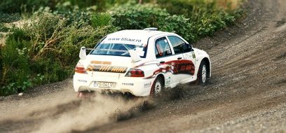 racing car in the dust on the rally