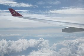 wing of a airplane of a Turkish airline above the clouds