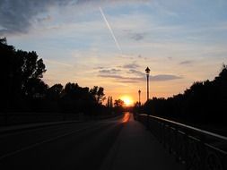 sunset over the bridge and trees