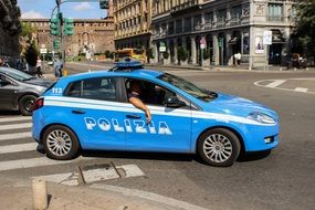 blue police car on the road