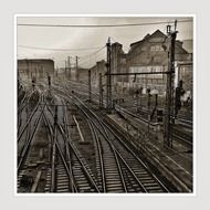 black and white photo of railway tracks at the station