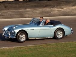 austin healey classic car with passengers