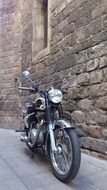 motorcycle near the stone wall