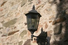street lamp on a stone wall