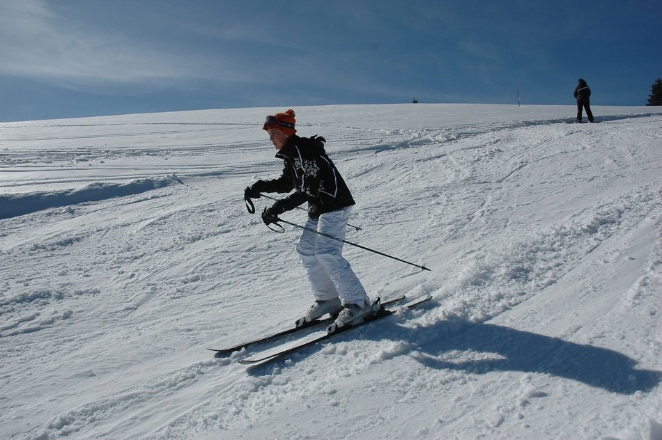 woman is skiing down the mountain