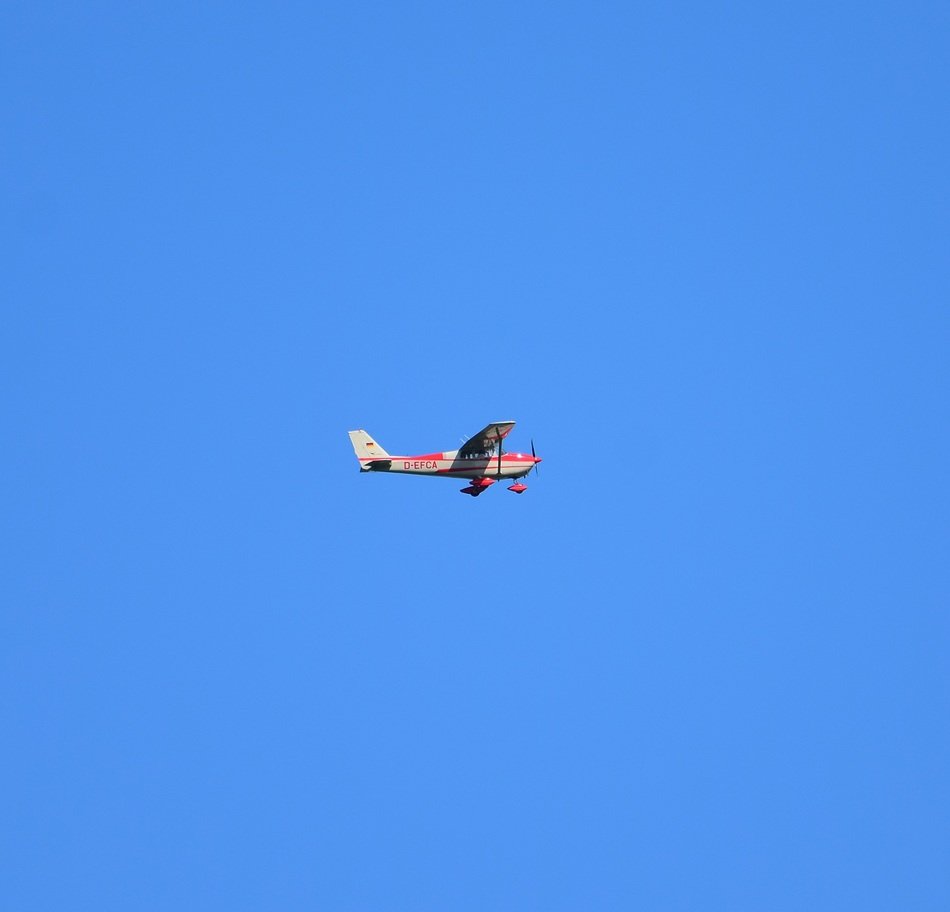 small plane in the blue sky