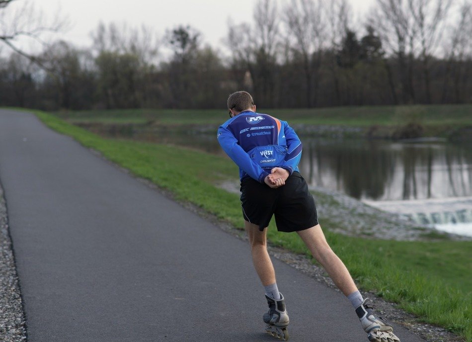 skater trains on the track along the river