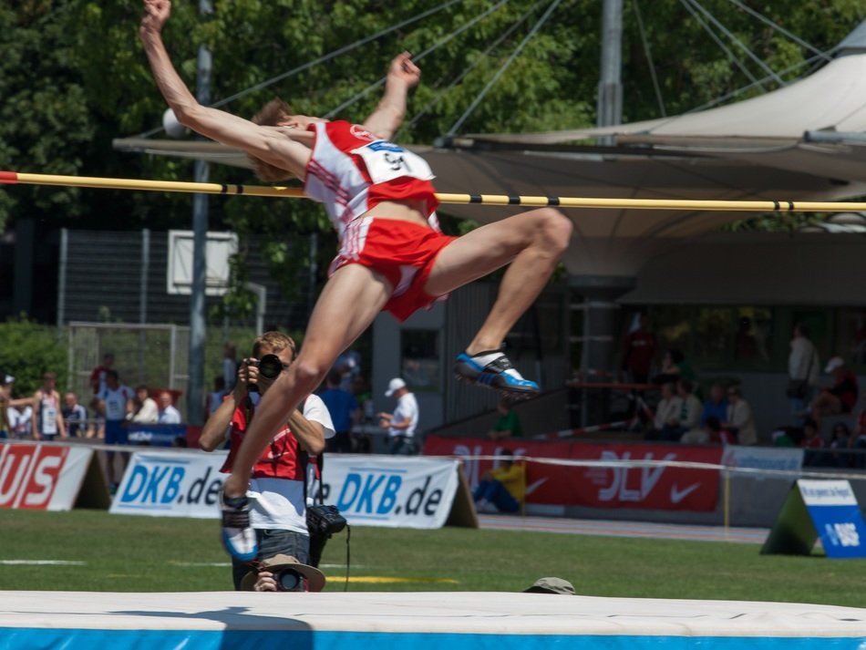 Athlete in a red uniform in a jump