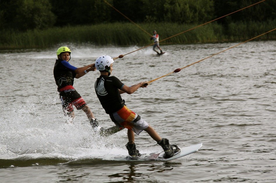 two athletes on the water skiing on the lake