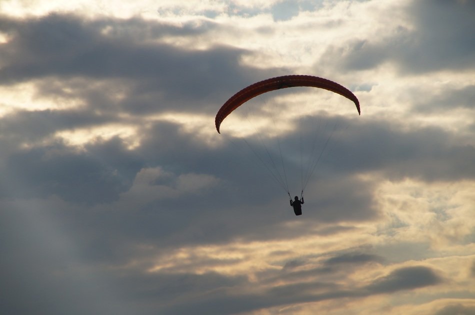 paraglider at cloudy evening sky