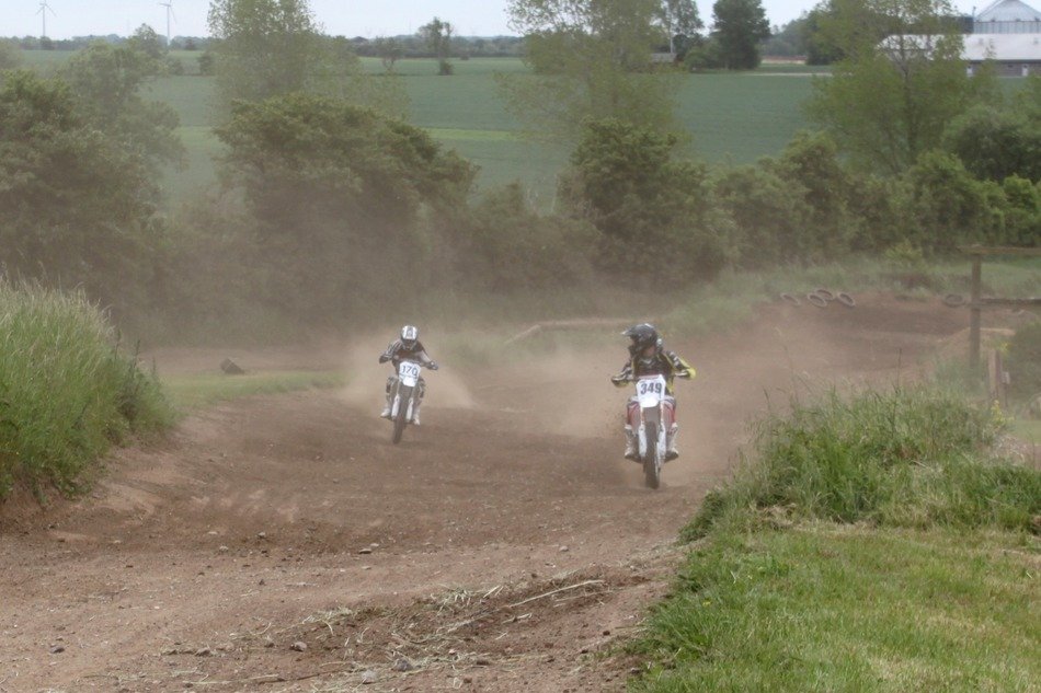motorcyclists driving on the highway in the dust