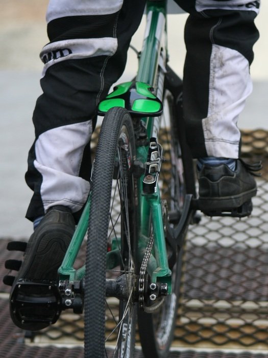 legs on the pedals of the bike