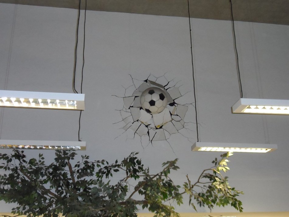 Football ball in the broken wall