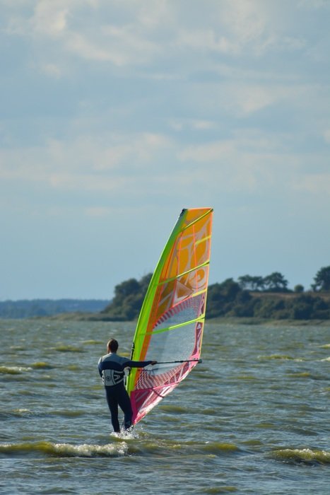 surfer with sail on the waves