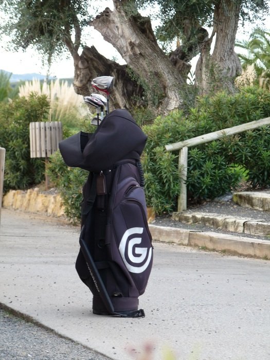Golf bag standing on a sidewalk