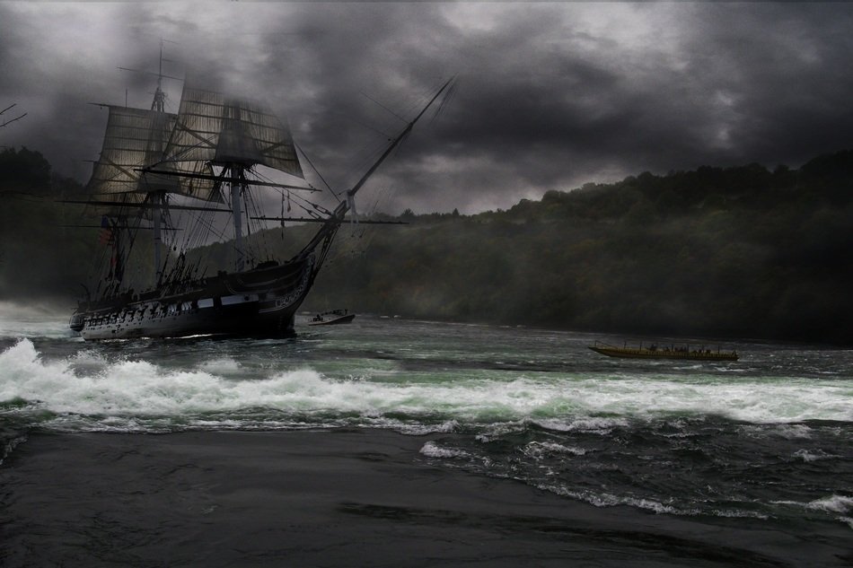 Sailboat in bad weather near the shore