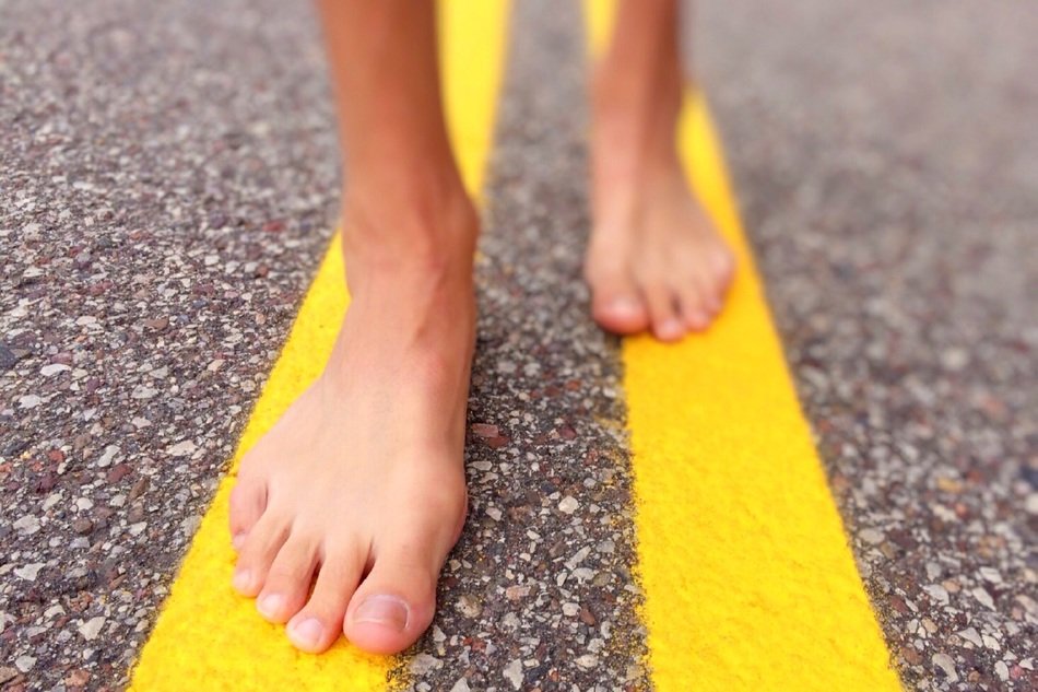 bare feet on the yellow dividing line