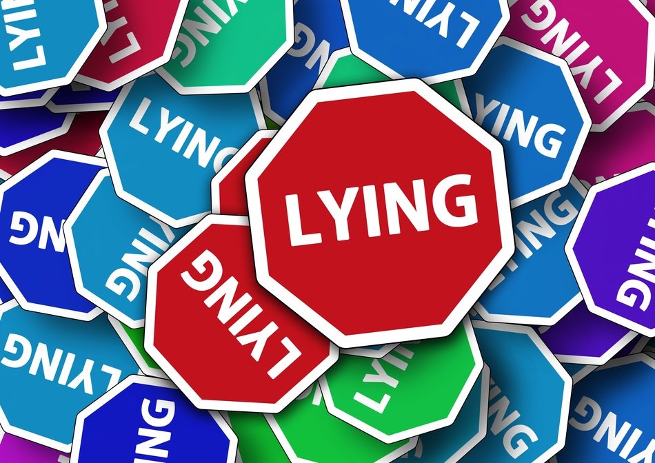 road signs with the word lying