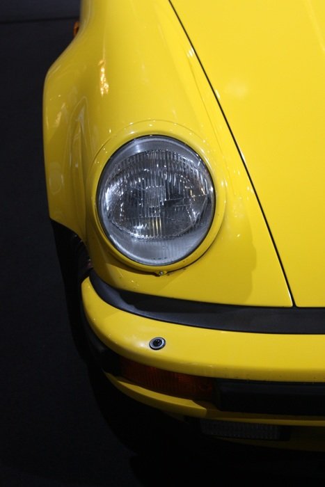 headlight of the yellow Porsche close-up