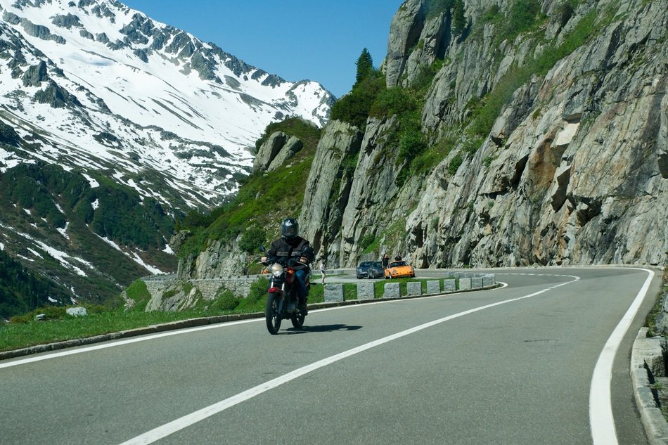 man on a motorcycle on the alpine road