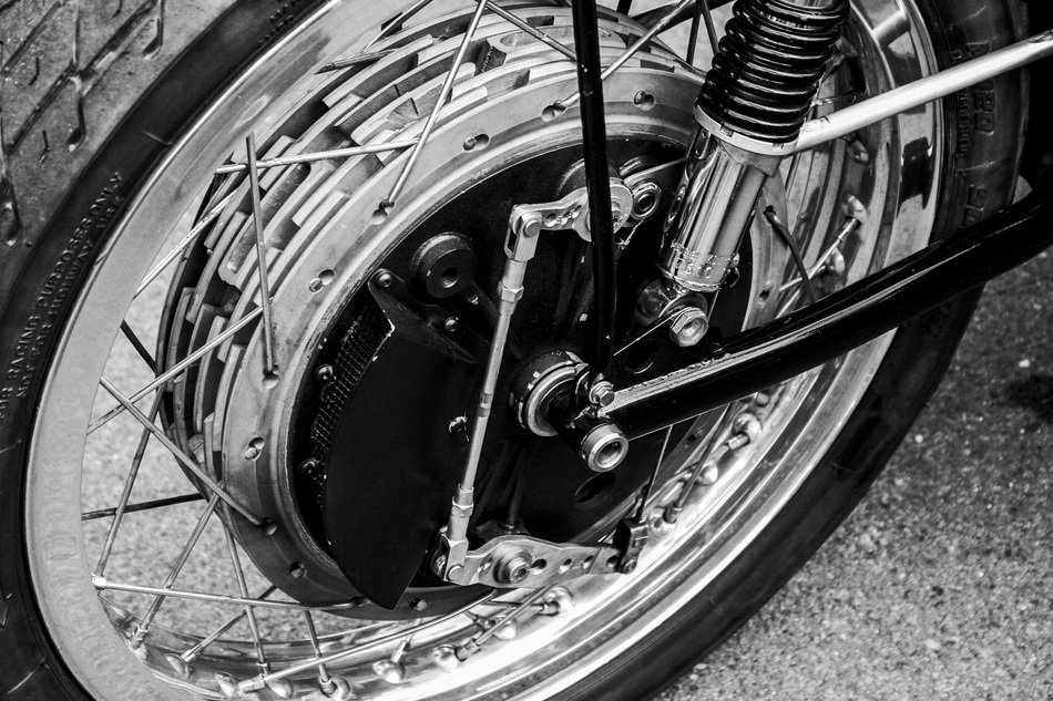 Black and white photo of motorcycle's front wheel