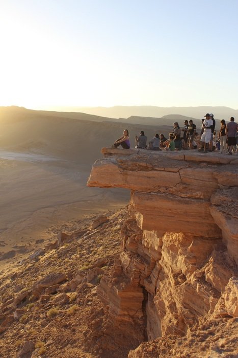 tourists on the cliff above the atakama desert