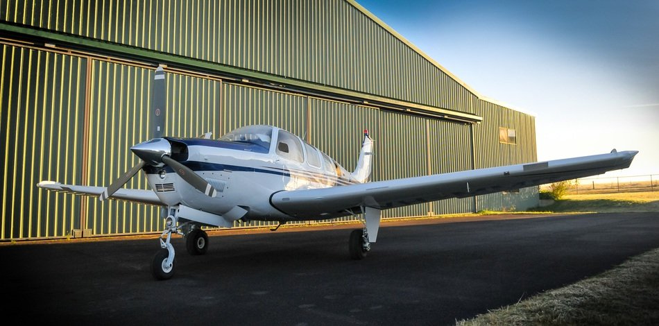 private plane with a propeller on the background of the hangar
