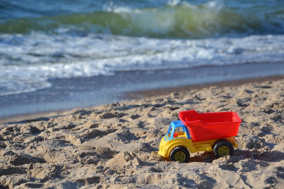 bright kids truck in the sand on the beach