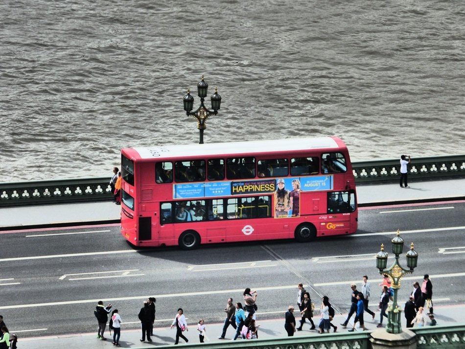 red touristic bus in london street scene