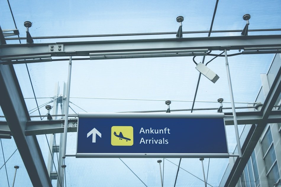 airport arrivals sign at sky