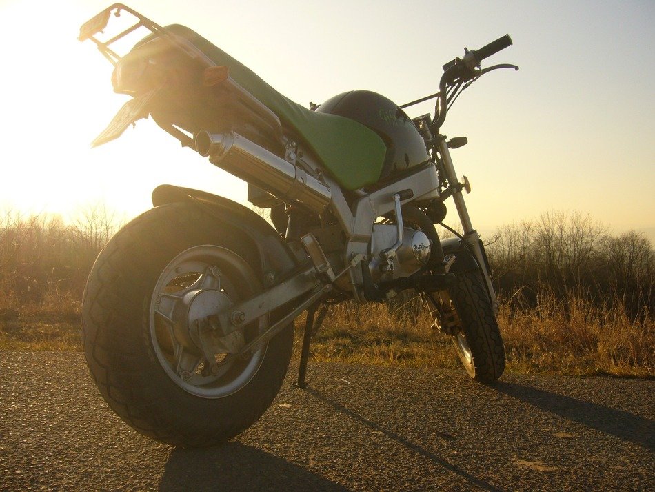 motorcycle on the road in the rays of light