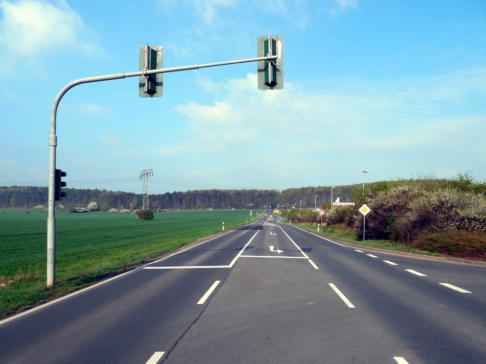 rear view of traffic lights pole over empty road