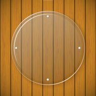 Round glass plate on the background of wooden wall