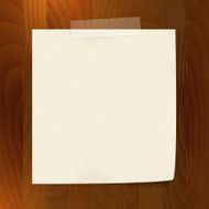 blank note paper with tape on wood background