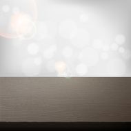 empty wooden table over abstract grey wall