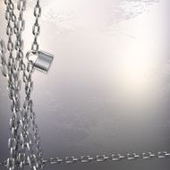 Metal chain and padlock on gray metal background