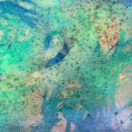 Pastel colors mottled with paint splatters on paper