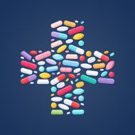 Colorful pills in cross shape background