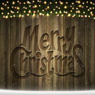 Merry Christmas lettering on Wooden background with bright garland snow