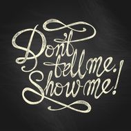 &quot;Don&#039;t Tell Me Show Me&quot; quote on the blackboard background N2