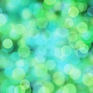 Blurred green and blue bokeh dots on black background