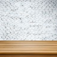 wooden table over white brick wall