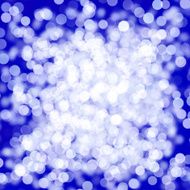 blurred white dot cluster on blue background
