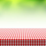 Picnic table covered with checkered tablecloth